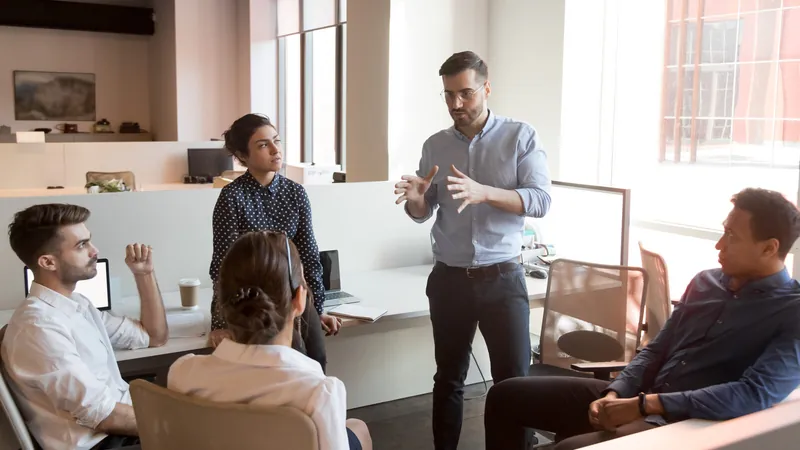 Consultant leading a team meeting in an open office