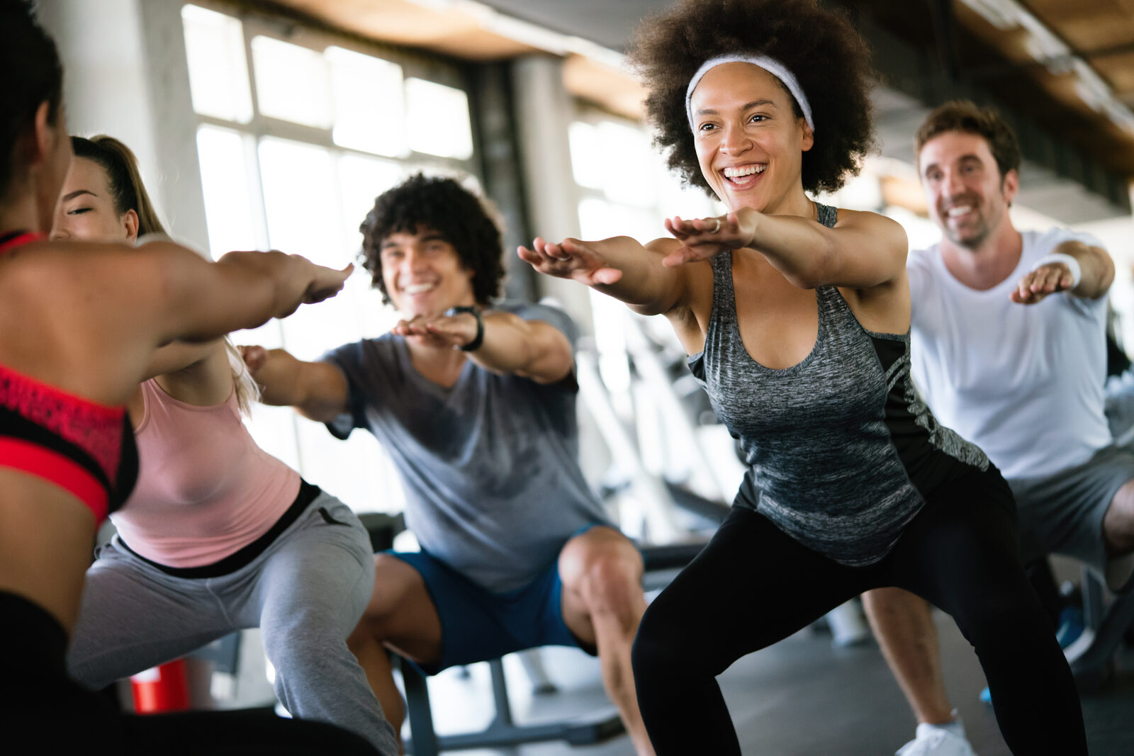 Fitness class doing squats together