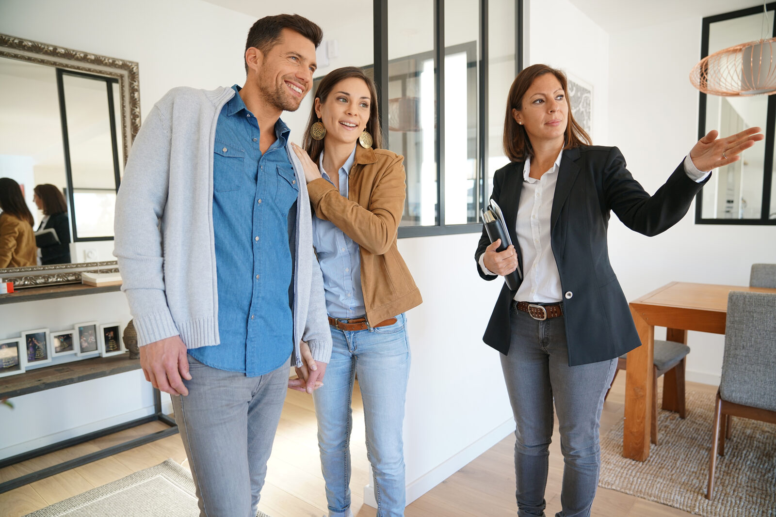 Real estate agent showing a home to a couple